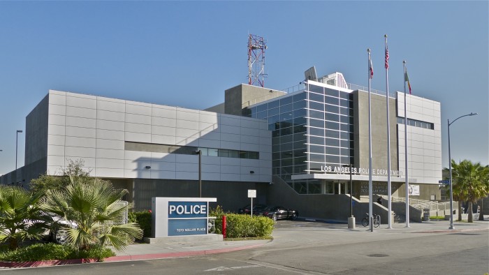 Exterior of LAPD headquarters showing Heliostat for rainbow light art installation on roof (left of flag poles)