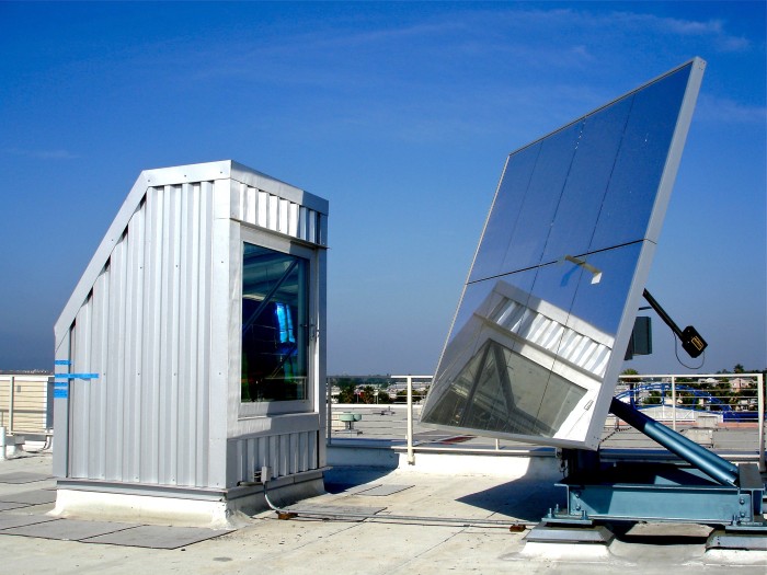 heliostat solar tracking mirror light into solar prism and rainbow light art installation. Erskine Solar Art