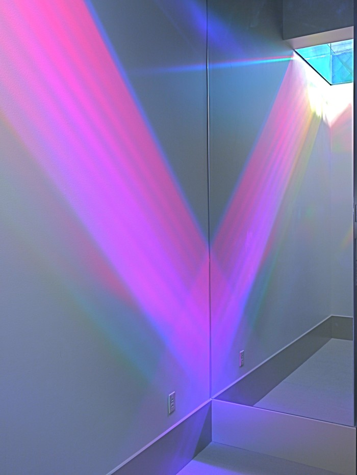 Magenta slab of rainbow light reflected in art installation mirror. Erskine Solar Art