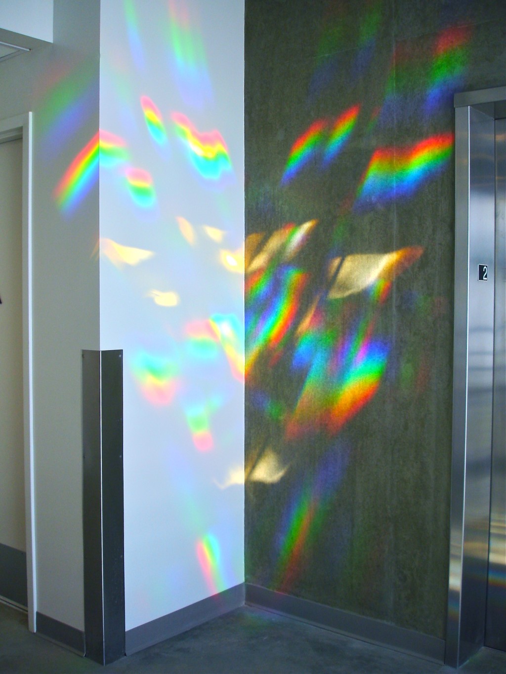 detail of rainbow light art splashes on LAPD lobby elevator. Erskine Solar Art
