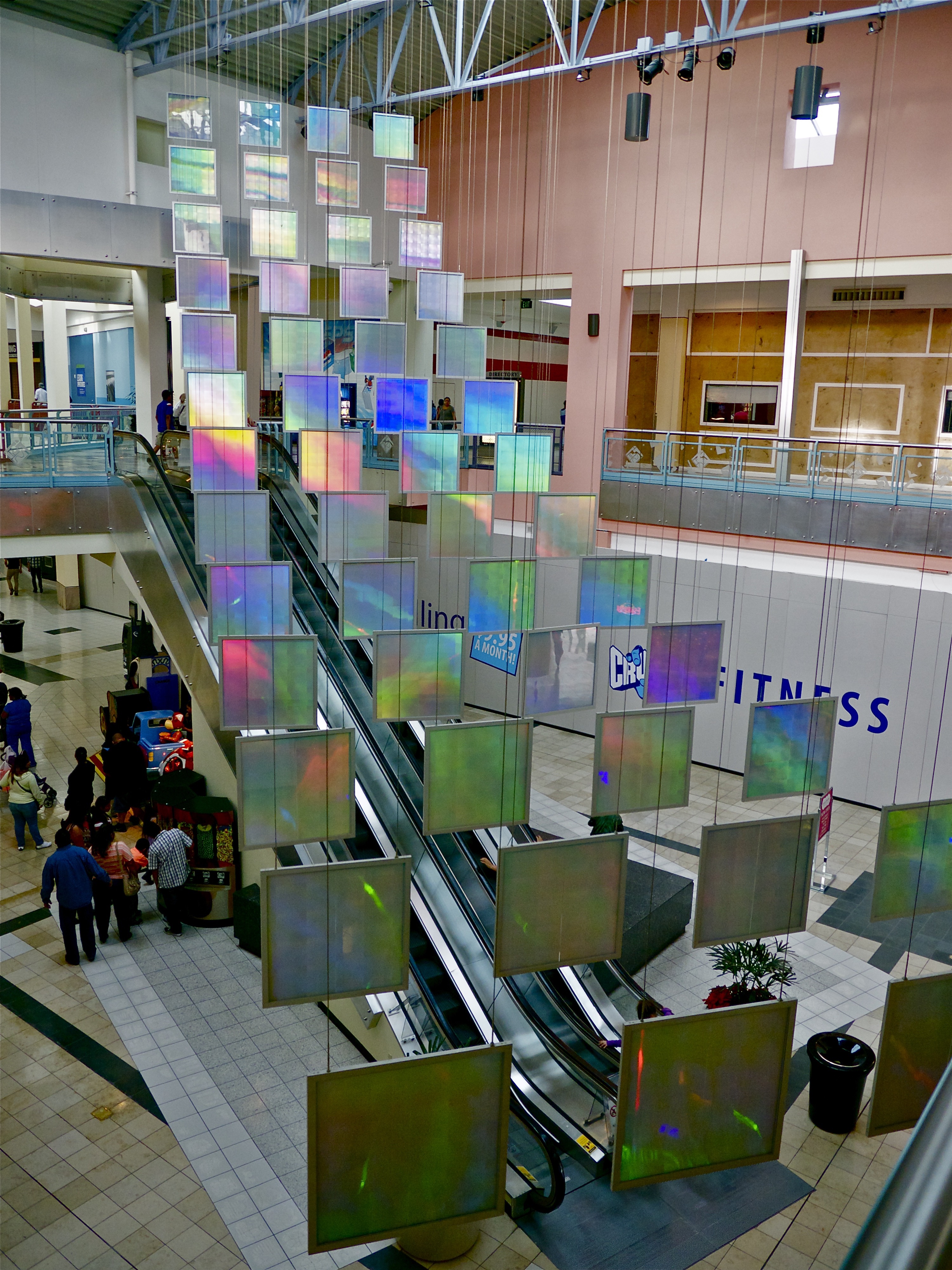 52, 36" x 36" suspended, glowing, colorful rainbow prism panels hang suspended in this light art installation